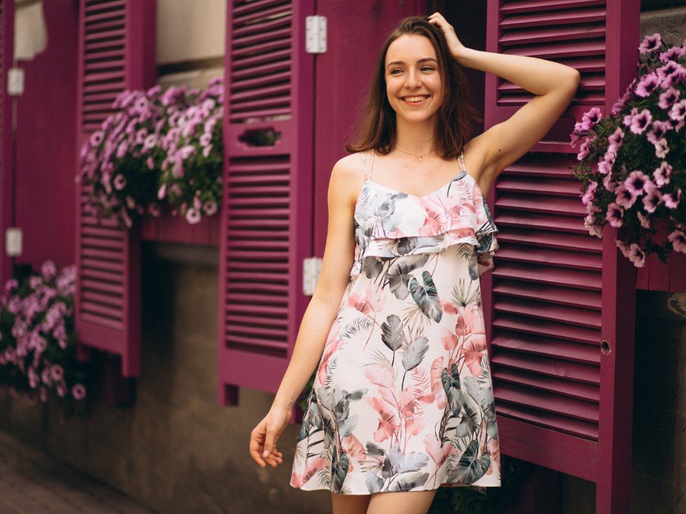 portrait happy woman outside cafe decorated with flowers